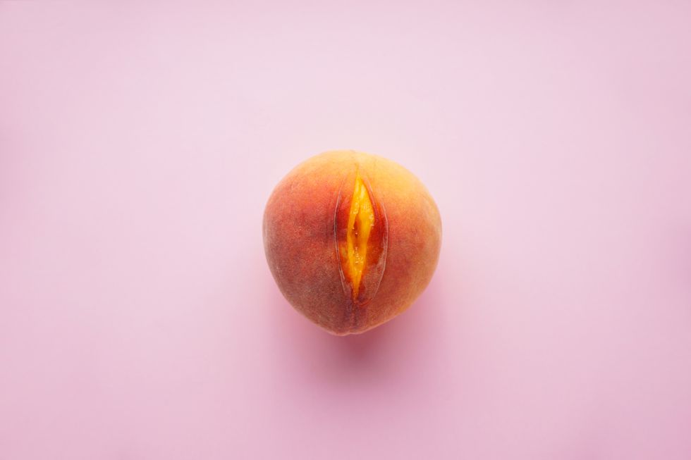 flat lay composition with juicy peach on a pink background