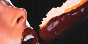 a close up of a woman putting a chocolate eclair in her mouth