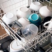 bowls mugs and tupperware in top rack of dishwasher