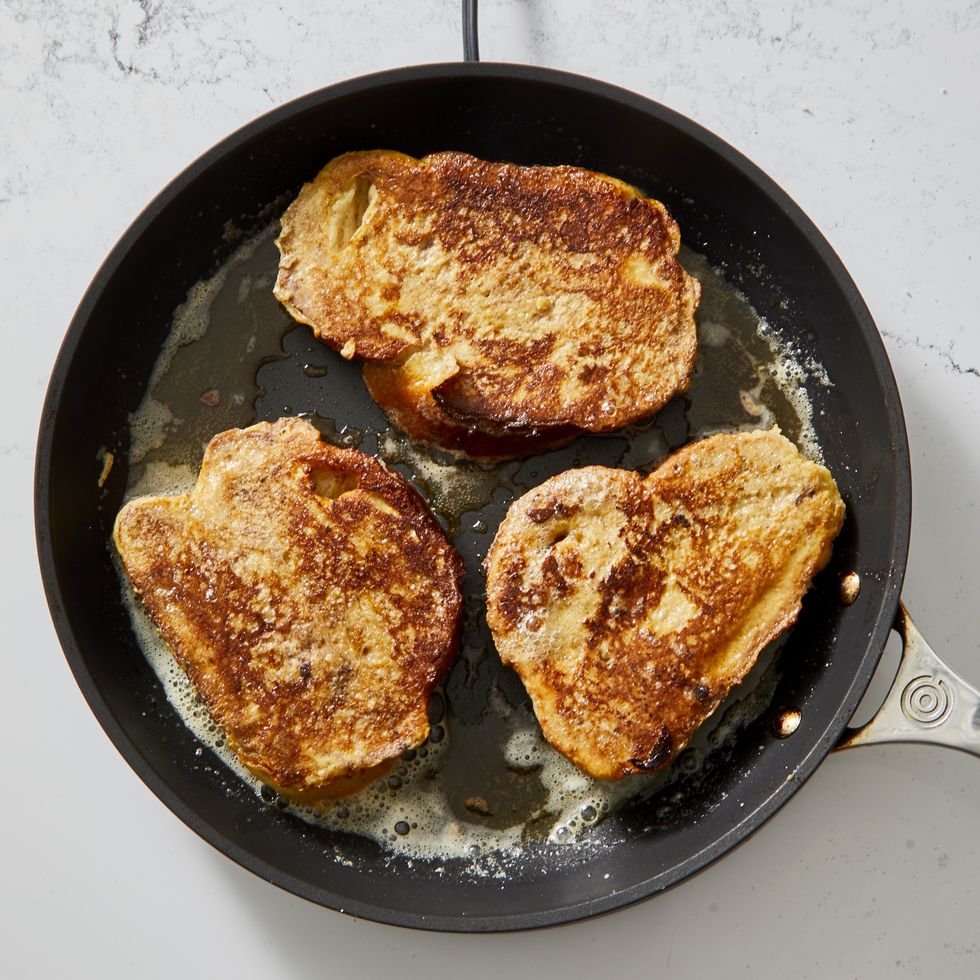 cooking french toast slices in a pan