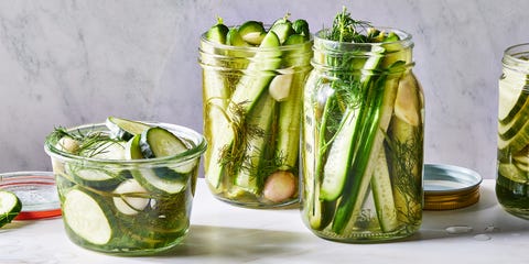homemade pickles in a jar with garlic cloves and herbs