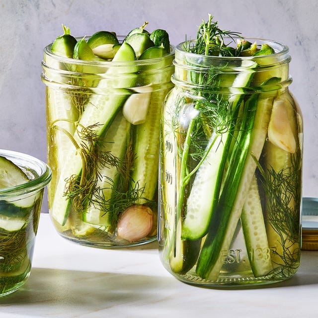 homemade pickles in a jar with garlic cloves and herbs