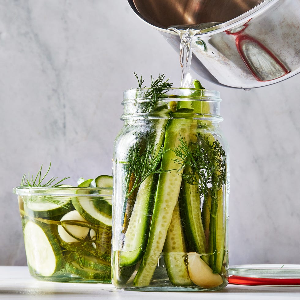 homemade pickles in a jar with garlic cloves and herbs