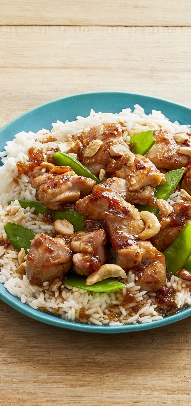 chicken snow pea stir fry over rice in blue bowl