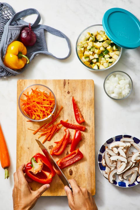 red bell pepper being cut up on a wooden board