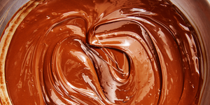 silky smooth melted milk chocolate in a stainless steel bowl