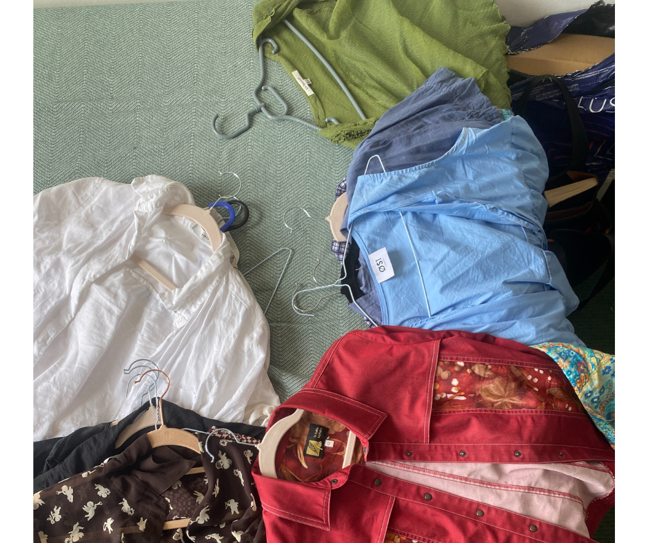 assorted clothing items piled on a green surface