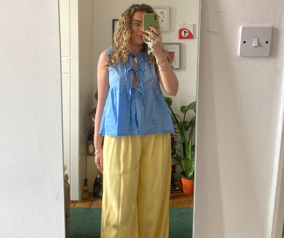 reflection showing a person in stylish casual attire