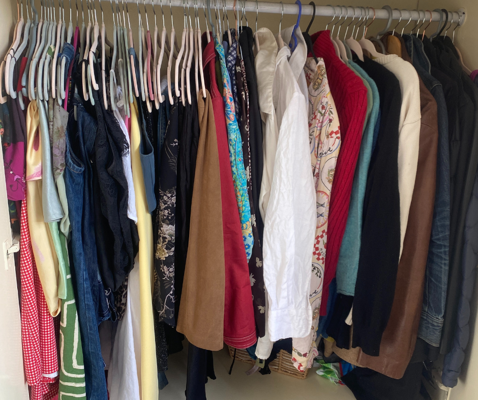 clothing hanging on a rack in a closet