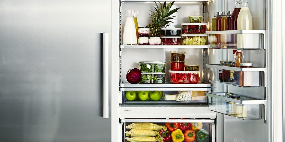 stainless steel fridge, halfway open with food inside