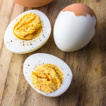 boiled chicken eggs on wooden board with pepper flakes