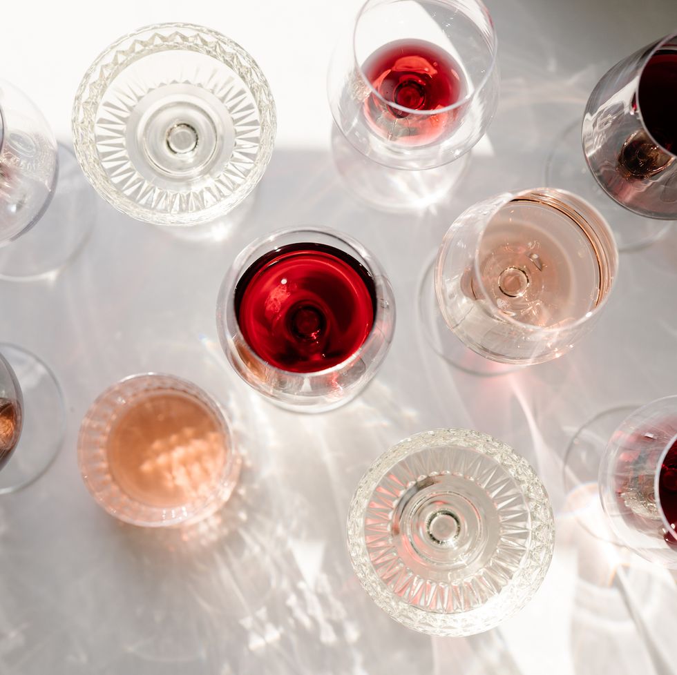 an overhead shot of empty and full wine glasses