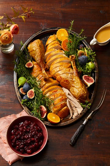 thanksgiving turkey on a platter with figs and herbs