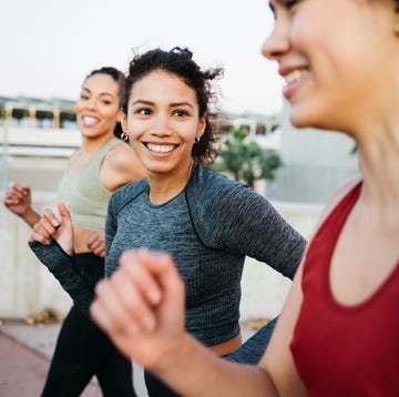 How to remove sweat stains three smiling young women, wearing sports clothes, jogging on an urban scenario