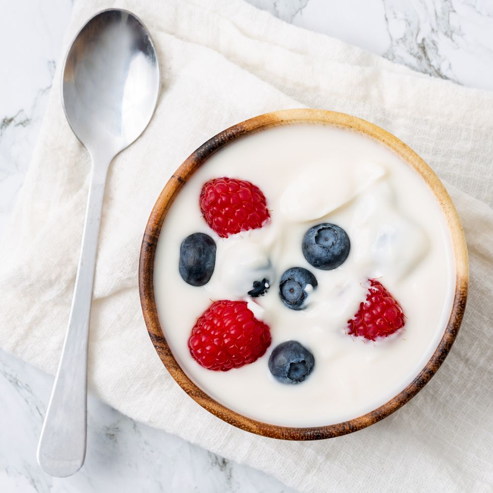 berry yogurt in a bowl and fresh blueberry, raspberry