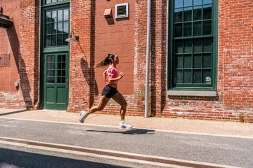 person jogging past a brick building