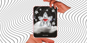 two hands hold out the tarot card the star over a background of white and black wavy lines