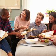 group of friends taking part in book club at home