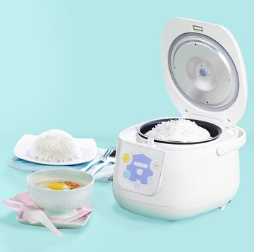 a white rice cooker with cooked white rice inside