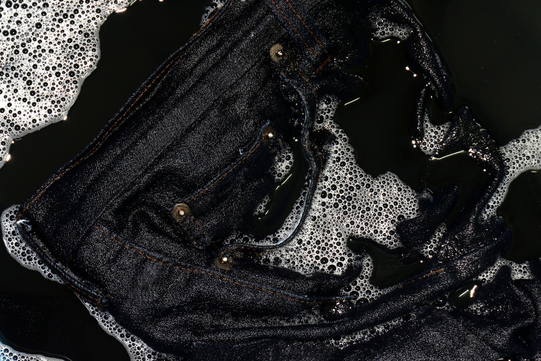 Washing new hot sale black jeans