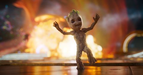 baby groot is oblivious to the fire behind him in a scene from guardians of the galaxy vol 2, the 15th movie if you want to watch all the marvel movies in order