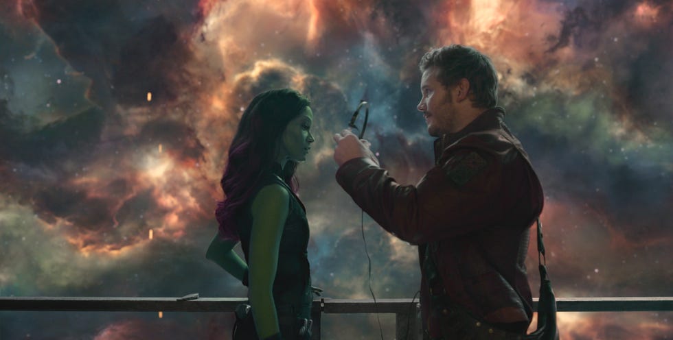 <b>peter</b> quill gives his headphones to <b>gamora</b> in a scene from guardians of the...