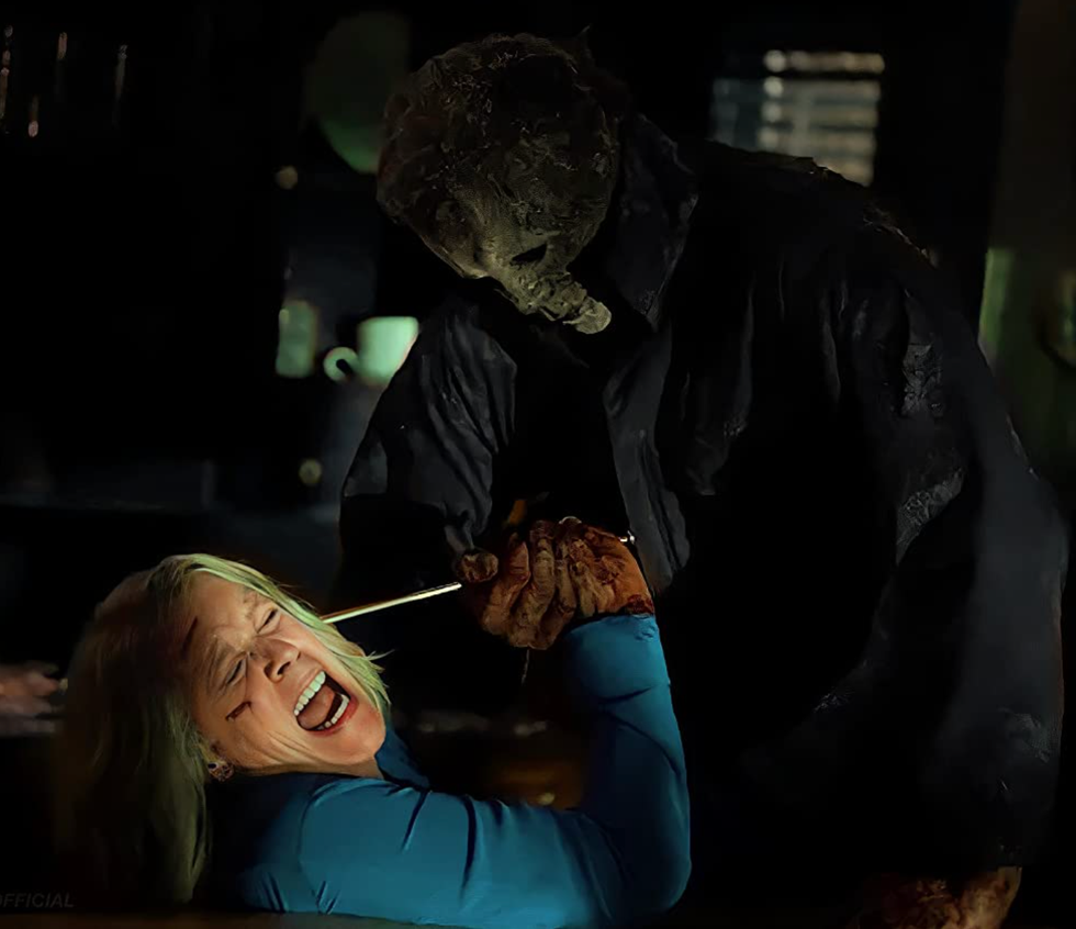 jamie lee curtis as laurie strode battling it out with nick castle as michael meyers in halloween ends