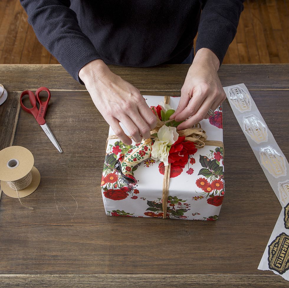 The process of wrapping christmas gifts. Wrapping paper, scissors in