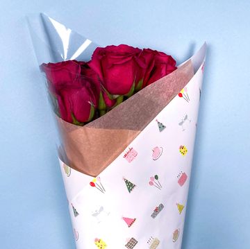 bouquet of roses wrapped in birthday wrapping paper