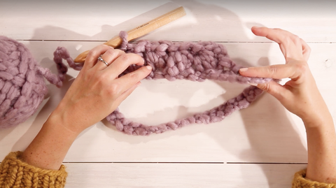 how to crotchet for beginners, woman making a bobble cowl