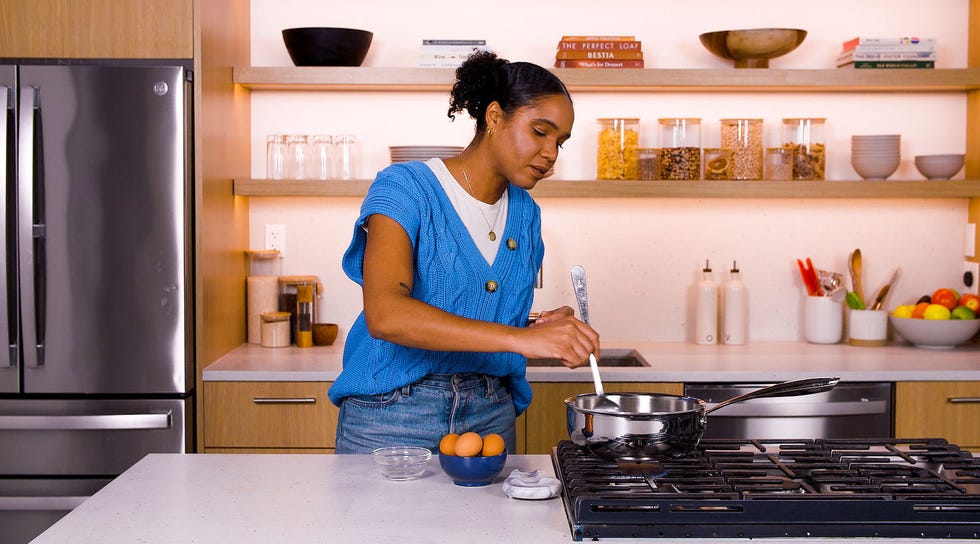 Brooke is cooking in the kitchen