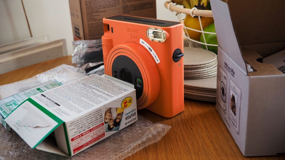 an instax instant camera with its box