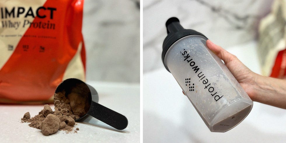 a scoop of protein powder on a work surface, and a hand holding a protein shaker