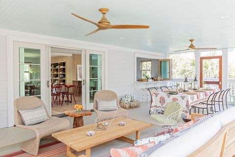 screened in porch with dining table and seating area, wooden ceiling fans,