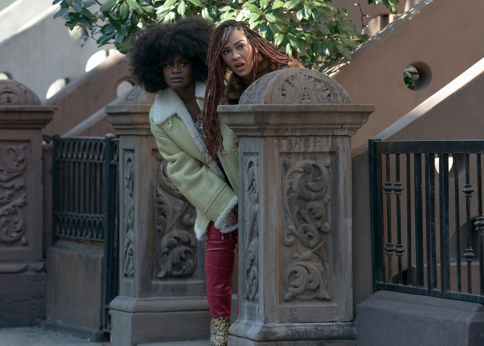 angie and camille hiding near a brownstone in harlem