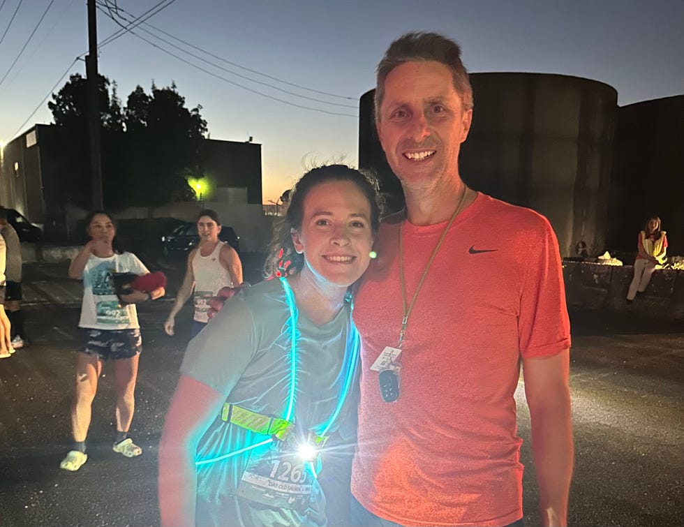 participants in a night running event including a person wearing a reflective vest