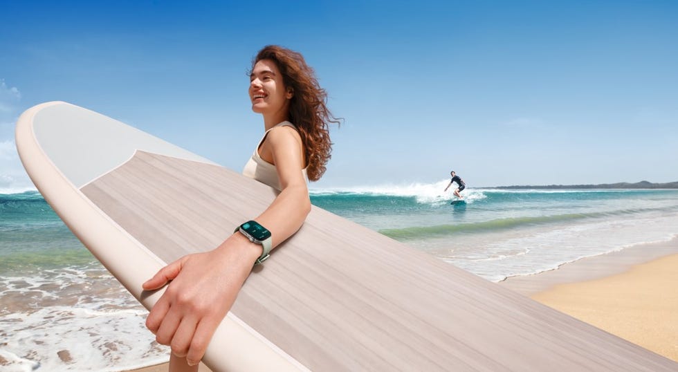 a person holding a surfboard on a beach