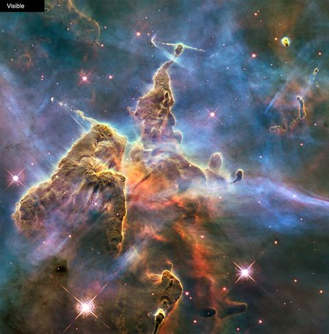 visible light image of mystic mountain, a pillar of gas dust and newborn stars in the carina nebula taken by ﻿the hubble telescope