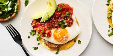 huevos rancheros topped with avocado, cotija and cilantro