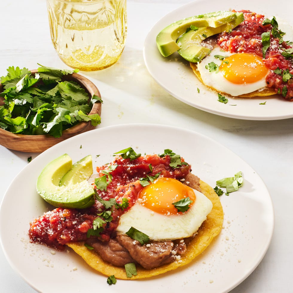 huevos rancheros topped with avocado, cotija and cilantro