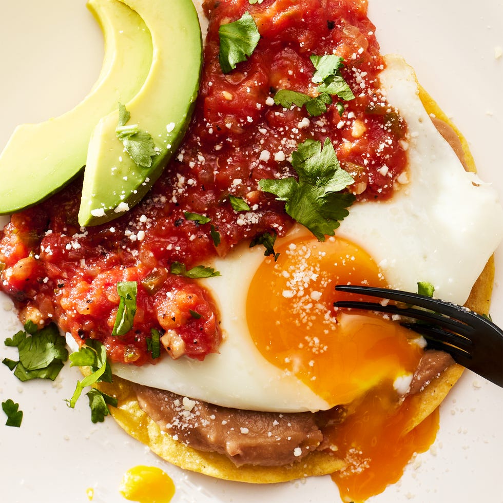 huevos rancheros topped with avocado, cotija and cilantro