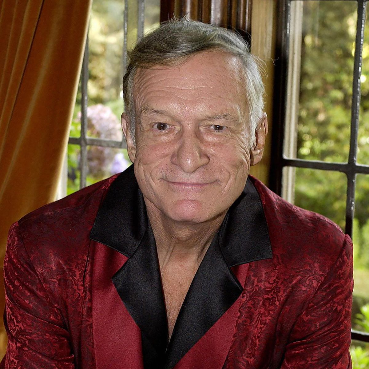 Playboy magazine founder Hugh Hefner posLOS ANGELES, UNITED STATES: Playboy magazine founder Hugh Hefner poses at his Los Angeles, California home, 19 November, 2003. Fifty years after Hefner launched Playboy and a sexual revolution, the pop culture icon is moving to reinvent its 'Swinging 60s' image for a new generation of pleasure seekers. From an idea born on Hefner's Chicago kitchen table, Playboy has become a huge business empire and one of the world's most recognisable brands. With its centre-fold pinups, the magazine has evolved from what was regarded as smut into a glamor publication that Sharon Stone, Cindy Crawford and Kim Basinger and other stars clamoured to pose nude for. Playboy will be celebrating its 50th Anniversary this December. AFP PHOTO/RICH SCHMITT (Photo credit should read RICH SCHMITT/AFP via Getty Images)