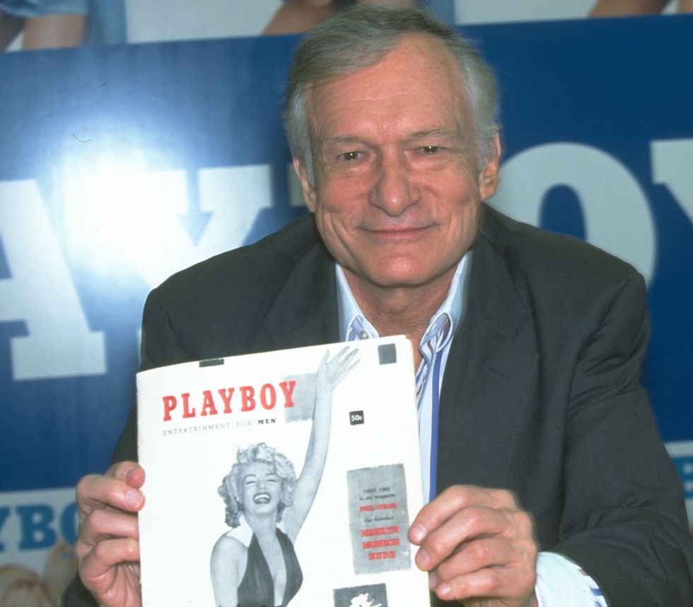 Hugh Hefner holding the first issue of Playboy, featuring Marilyn Monroe on the cover