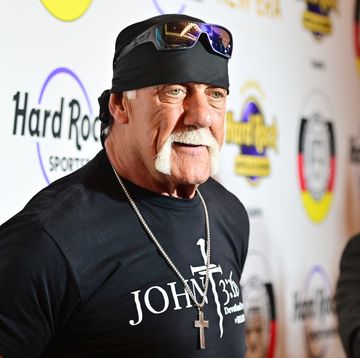 hulk hogan wearing a bandana with sunglasses on his forehead and smiling in a photo
