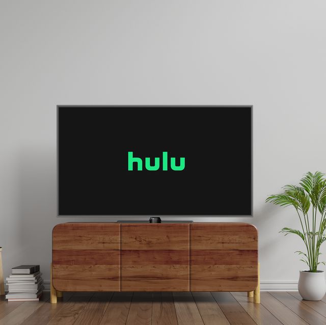 tv with hulu logo on screen on top of cabinet in between plants