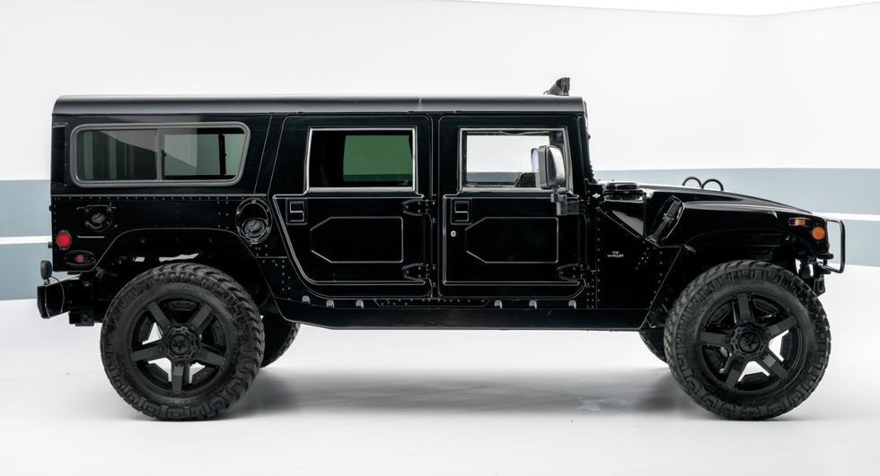 a black jeep with large wheels