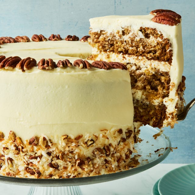 layered cake with frosting topped with pecans
