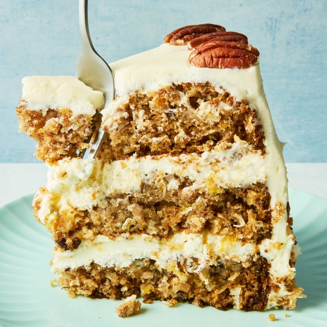 layered cake with frosting topped with pecans