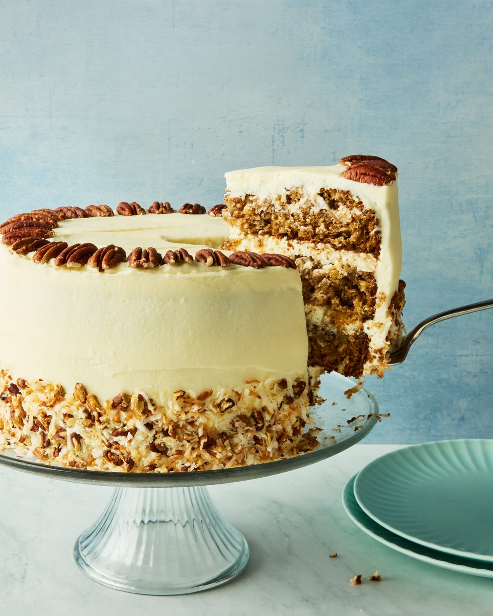 layered cake with frosting topped with pecans