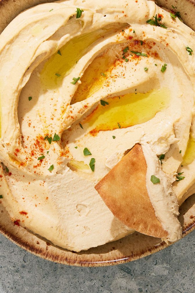 hummus drizzled with olive oil and paprika served with pita